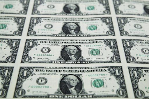 FILE - A sheet of new $1 bills is seen, Nov. 15, 2017, at the Bureau of Engraving and Printing in Washington. (AP Photo/Jacquelyn Martin, File)