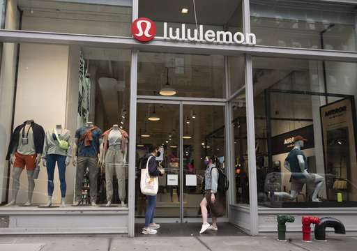 FILE - Lululemon fashions are displayed in company store windows, March 25, 2021, in New York. (AP Photo/Mark Lennihan, File)