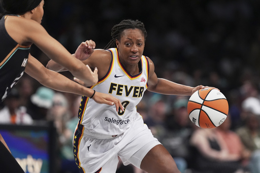 Indiana Fever's Kelsey Mitchell (0) drives past New York Liberty's Isabelle Harrison during the second half of a WNBA basketball game Wednesday, July 16, 2025, in New York. (AP Photo/Frank Franklin II)