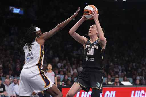 New York Liberty's Breanna Stewart (30) shoots over Indiana Fever's Natasha Howard (6) during the first half of a WNBA basketball game Wednesday, July 16, 2025, in New York. (AP Photo/Frank Franklin II)