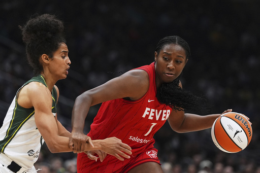 Indiana Fever forward Aliyah Boston (7) drives to the basket against Seattle Storm guard Skylar Diggins, left, during the first half of a WNBA basketball game Tuesday, June 24, 2025, in Seattle. (AP Photo/Lindsey Wasson)