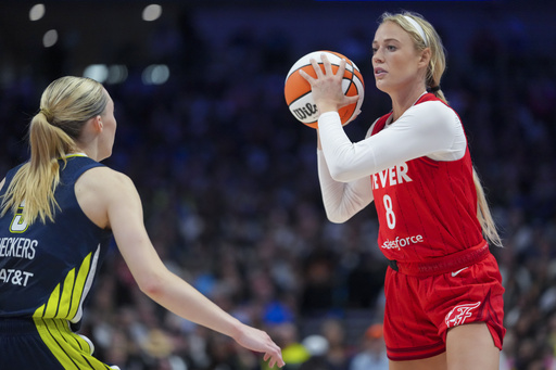 Indiana Fever guard Sophie Cunningham, right, works the floor against Dallas Wings guard Paige Bueckers during the first half of a WNBA basketball game Friday, June 27, 2025, in Dallas. (AP Photo/Julio Cortez)