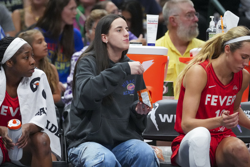 Indiana Fever guard Caitlin Clark eats Goldfish crackers during the first half of a WNBA basketball game against the Dallas Wings Friday, June 27, 2025, in Dallas. (AP Photo/Julio Cortez)