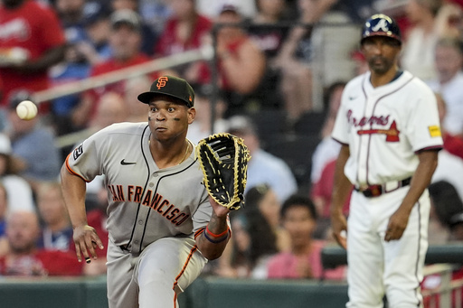 San Francisco Giants' Rafael Devers (16) makes the tag on Atlanta Braves' Nick Allen (2) at first base in the fifth inning of a baseball game, Tuesday, July 22, 2025, in Atlanta. (AP Photo/Mike Stewart)