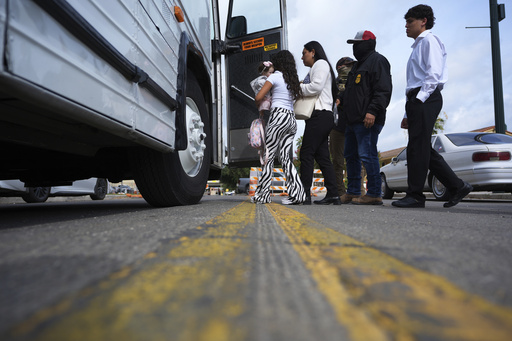 A family from Colombia is detained and escorted to a bus by federal agents following an appearance at immigration court Monday, July 14, 2025, in San Antonio. (AP Photo/Eric Gay)