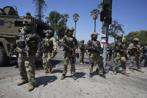 FILE - Federal agents stage at MacArthur Park Monday, July 7, 2025, in Los Angeles. (AP Photo/Damian Dovarganes,File)
