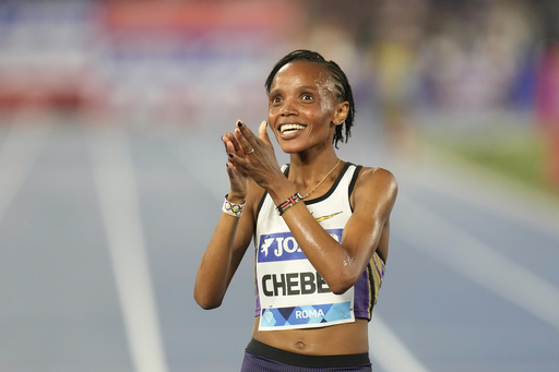 Beatrice Chebet, of Kenya, celebrates after crossing the finish line to win the women 5000 meters at the Diamond League Golden Gala Pietro Mennea athletics meet at the Stadio Olimpico in Rome, Friday, June 6, 2025. (AP Photo/Gregorio Borgia)
