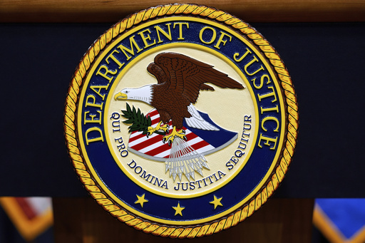FILE - The U.S. Department of Justice logo is seen on a podium before a press conference, May 6, 2025, at the Justice Department in Washington. (AP Photo/Julia Demaree Nikhinson, File)