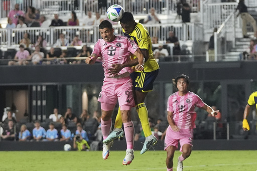 Inter Miami forward Luis Suarez (9) heads the ball against Nashville SC defender Jeisson Palacios (4) during the second half of an MLS soccer match, Saturday, July 12, 2025, in Fort Lauderdale, Fla. (AP Photo/Lynne Sladky)