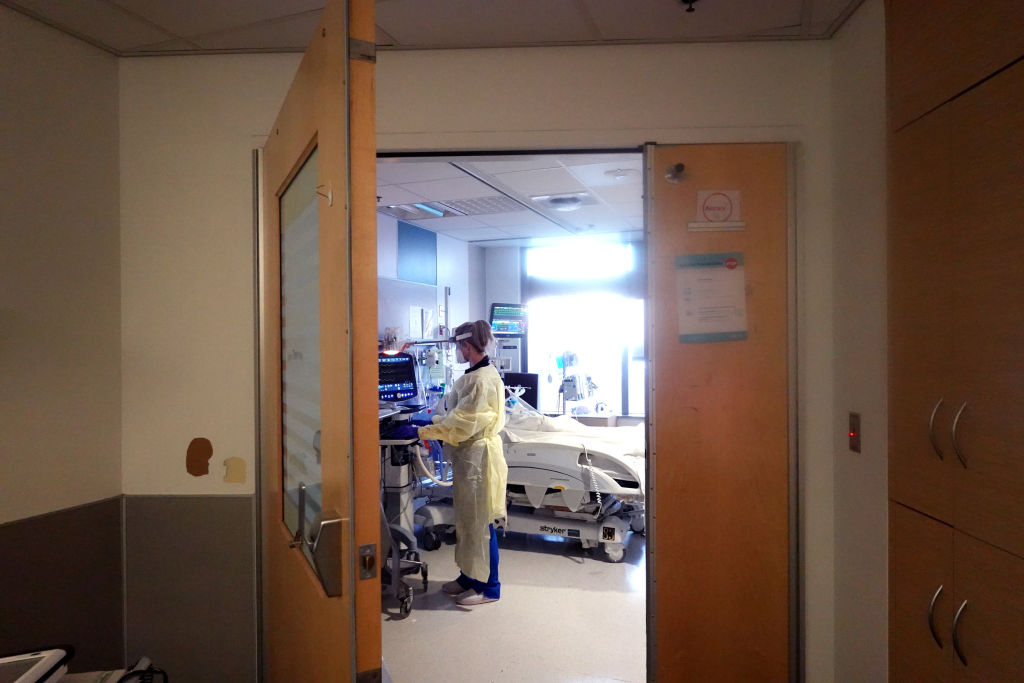 Respiratory therapist Joanna Bielski checks on a COVID-19 patient in the ICU at Rush University Medial Center on Jan. 31, 2022, in Chicago. (Scott Olson/Getty Images)
