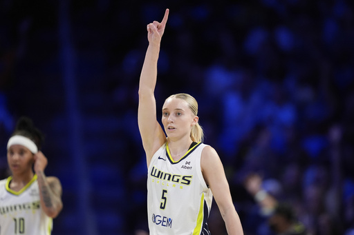 Dallas Wings guard Paige Bueckers celebrates after a basket in the second half of a WNBA basketball game against the Phoenix Mercury Thursday, July 3, 2025, in Arlington, Texas. (AP Photo/Tony Gutierrez)