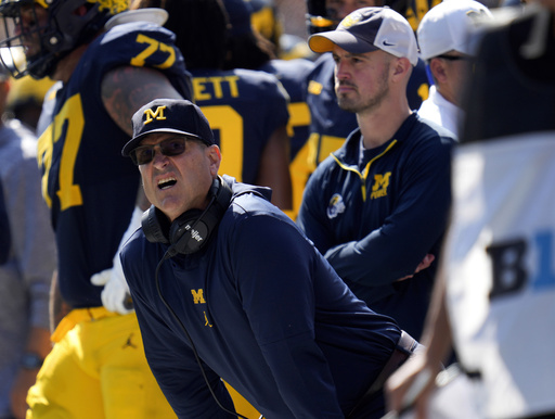 FILE - Michigan head coach Jim Harbaugh, front left, watches against Rutgers as analytics assistant Connor Stalions, right, looks on during an NCAA college football game in Ann Arbor, Mich., Sept. 23, 2023. (AP Photo/Paul Sancya, file)
