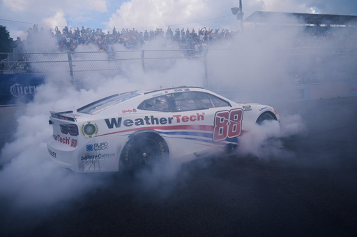Shane van Gisbergen does a victory burnout after winning a NASCAR Cup Series auto race at the Grant Park 165, Sunday, July 6, 2025, in Chicago. (AP Photo/Erin Hooley)