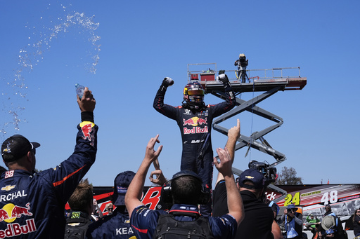Shane van Gisbergen, center, celebrates with his crew after winning a NASCAR Cup Series auto race at Sonoma Raceway, Sunday, July 13, 2025, in Sonoma, Calif. (AP Photo/Godofredo A. Vásquez)
