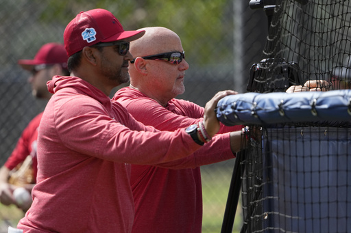 FILE - Washington Nationals manager Dave Martinez, left, watches with general manager Mike Rizzo during spring training baseball practice Saturday, Feb. 18, 2023, in West Palm Beach, Fla. (AP Photo/Jeff Roberson, File)