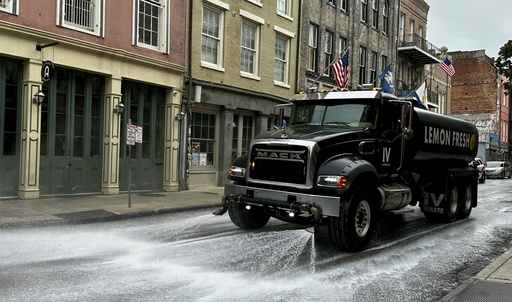 A sanitation truck spraying lemon scented soap rolls down Decatur Street in the French Quarter, Wednesday, July 23, 2025, in New Orleans. (AP Photo/Stephen Smith)