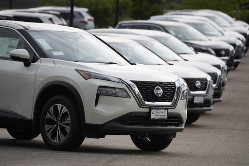 FILE - Unsold 2021 Rogue sports-utility vehicles sit on a lot at a Nissan dealership Colorado on June 27, 2021. (AP Photo/David Zalubowski, File)