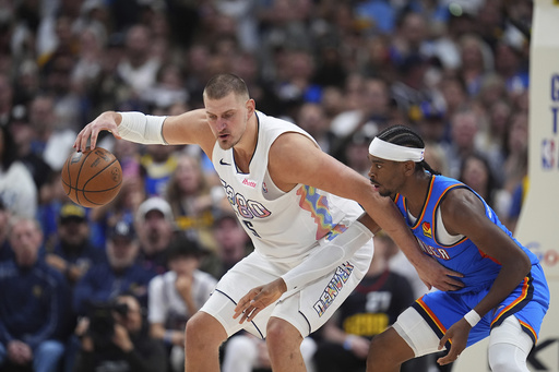 FILE - Denver Nuggets center Nikola Jokic (15) and Oklahoma City Thunder guard Shai Gilgeous-Alexander (2) in the second half of Game 6 in the Western Conference semifinals of the NBA basketball playoffs on May 15, 2025, in Denver. (AP Photo/David Zalubowski, File)