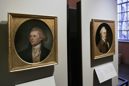 FILE - Portraits of a red-headed Thomas Jefferson, left, and John Dickinson, right, by by Charles Willson Peale are seen at the refurbished Second Bank of the United States in Philadelphia on Nov. 26, 2004. (AP Photo/Jacqueline Larma, File)