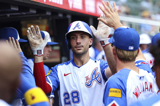 Atlanta Braves' Matt Olson (28) high-fives teammates in the dugout after hitting a solo home run in the third inning of a baseball game against the Baltimore Orioles, Saturday, July 5, 2025, in Atlanta. (AP Photo/Colin Hubbard)