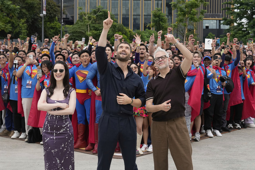 Superman stars David Corenswet, center, Rachel Brosnahan, left, and writer, director, and producer James Gunn pose with fans during the first stop of the Superman World Tour in Pasig city, Philippines on Thursday June 19, 2025. (AP Photo/Aaron Favila)