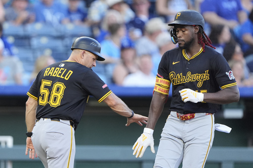 Pittsburgh Pirates' Oneil Cruz celebrates with third base coach Mike Rabelo (58) after hitting a solo home run during the fourth inning of a baseball game against the Kansas City Royals, Tuesday, July 8, 2025, in Kansas City, Mo. (AP Photo/Charlie Riedel)