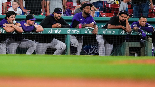 FILE - The Colorado Rockies rest on the dugout rail while trailing the Boston Red Sox in the ninth inning of a baseball game at Fenway Park, Tuesday, July 8, 2025, in Boston. (AP Photo/Charles Krupa, File)