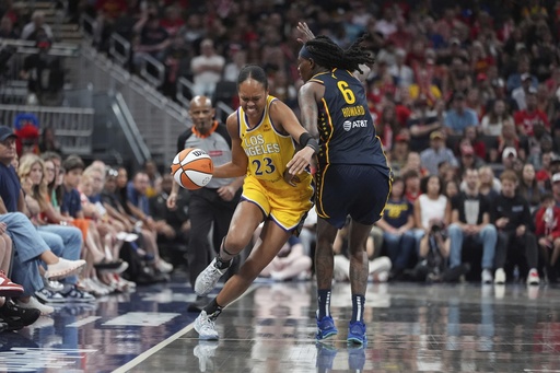 Los Angeles Sparks' Azura Stevens (23) goes by Indiana Fever's Natasha Howard (6) during the second half of a WNBA basketball game, Saturday, July 5, 2025, in Indianapolis. (AP Photo/Michael Conroy)