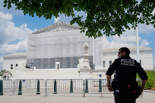 A U.S. Supreme Court police officer stands watch as anti-abortion protesters rally outside of the Supreme Court, Thursday, June 26, 2025, in Washington. (AP Photo/Mariam Zuhaib)
