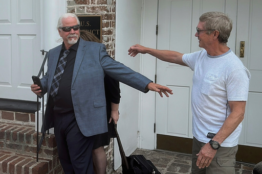 Bhagavan “Doc” Antle from the Netflix Tiger King documentary, center, reaches out to a supporter after he was sentenced to a year and a day in prison on federal animal trafficking and money laundering charges on Tuesday, July 8, 2025 in Charleston, S.C. (AP Photo/Jeffrey Collins)