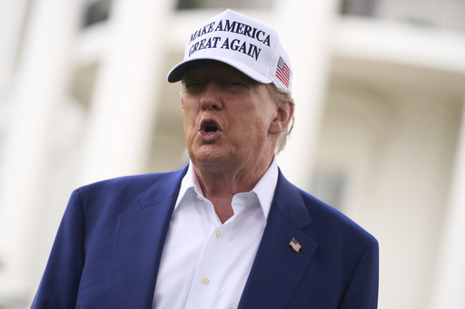 President Donald Trump talks with reporters before a flag pole is installed on the South Lawn of the White House, Wednesday, June 18, 2025, in Washington. (AP Photo/Evan Vucci)