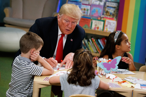 FILE - President Donald Trump colors during a visit with a group of children at the Nationwide Children's Hospital, Aug. 24, 2018, in Columbus, Ohio. (AP Photo/Evan Vucci, File)