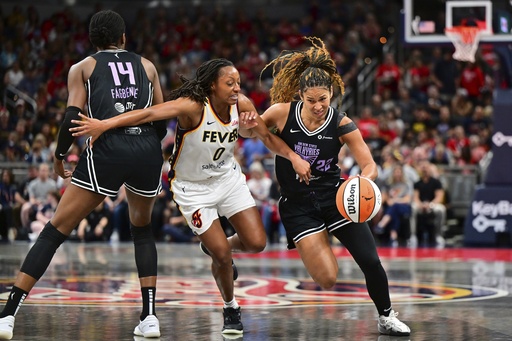 Golden State Valkyries' Veronica Burton (22) is defended by Indiana Fever's Kelsey Mitchell (0) during the first half of a WNBA basketball game, Wednesday, July 9, 2025, in Indianapolis. (AP Photo/Doug McSchooler)