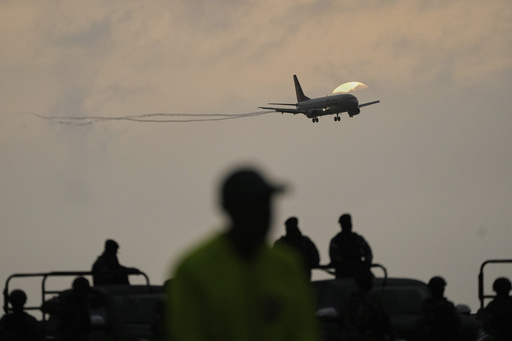 A plane carrying migrants deported months ago by the United States to El Salvador under the Trump administration's immigration crackdown lands at Simón Bolívar International Airport in Maiquetía, Venezuela, Friday, July 18, 2025. (AP Photo/Ariana Cubillos)