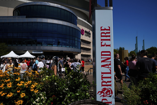People attend a launch event announcing Portland Fire as the name of Portland's WNBA basketball franchise outside the Moda Center on Tuesday, July 15, 2025, in Portland, Ore. (AP Photo/Jenny Kane)