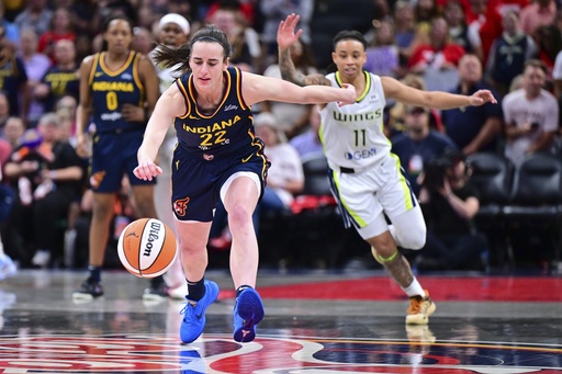 Indiana Fever's Caitlin Clark goes for a loose ball during the first half of a WNBA basketball game against the Dallas Wings, Sunday, July 13, 2025, in Indianapolis. (AP Photo/Doug McSchooler)