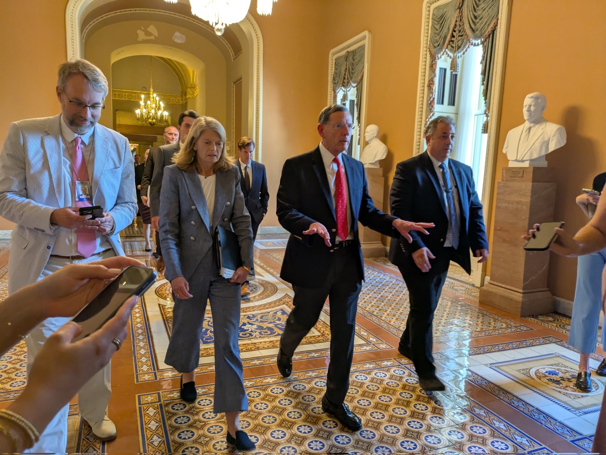 U.S. Sens. Lisa Murkowski of Alaska and John Barrasso of Wyoming, both Republicans, center, walk into the Senate chamber on Tuesday, July 1, 2025. (Photo by Ashley Murray/States Newsroom)