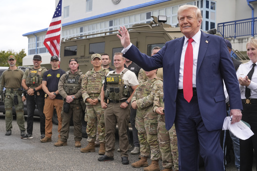 President Donald Trump speaks with members of law enforcement and National Guard soldiers, Thursday, Aug. 21, 2025, in Washington. (AP Photo/Jacquelyn Martin)
