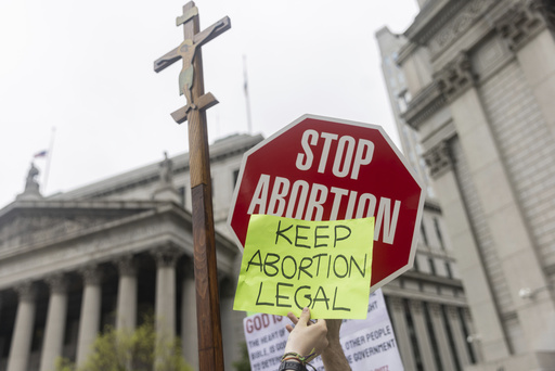 FILE - Protesters hold competing signs outside Manhattan federal court during an abortion-rights demonstration in New York, May 14, 2022. (AP Photo/Jeenah Moon, File)