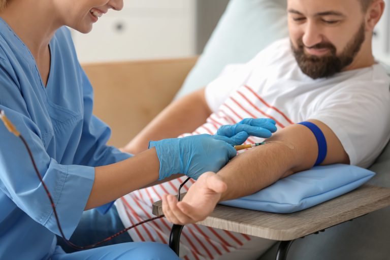 Man donating blood in hospital