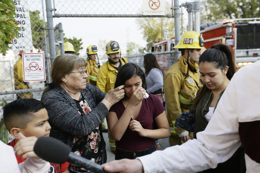 FILE - Student Marianna Torres, 11, center, cries as she evacuates Park Avenue Elementary School after jet fuel fell on the school in Cudahy, Calif., Jan. 14, 2020. (AP Photo/Damian Dovarganes, File)