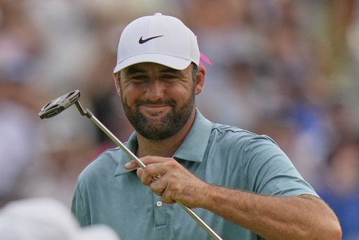 Scottie Scheffler celebrates on the 18th green after winning the BMW Championship golf tournament Sunday, Aug. 17, 2025, in Owings Mills, Md. (AP Photo/Stephanie Scarbrough)