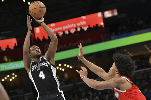 FILE - San Antonio Spurs guard De'Aaron Fox (4) shoots against Memphis Grizzlies forward Jaylen Wells in the first half of an NBA basketball game Saturday, March 1, 2025, in Memphis, Tenn. (AP Photo/Brandon Dill, file)