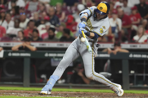 Milwaukee Brewers' Christian Yelich hits a solo home run in the sixth inning of a baseball game against the Cincinnati Reds, Friday, Aug. 15, 2025, in Cincinnati. (AP Photo/Kareem Elgazzar)