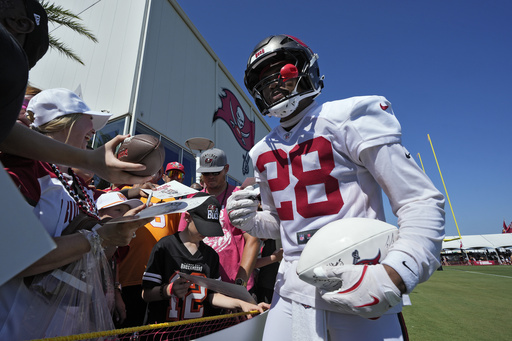 Tampa Bay Buccaneers safety Shilo Sanders signs autographs for fans during Back Together Weekend at an NFL football training camp practice Sunday, July 27, 2025, in Tampa, Fla. (AP Photo/Chris O'Meara)