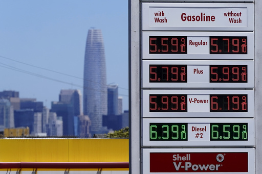 FILE - The Salesforce Tower and skyline are shown behind the gasoline price board at a gas station in San Francisco, July 20, 2022. (AP Photo/Jeff Chiu, File)