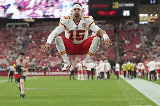 Kansas City Chiefs quarterback Patrick Mahomes jumps prior to an NFL preseason football game against the Arizona Cardinals, Saturday, Aug. 9, 2025, in Glendale. (AP Photo/Rick Scuteri)