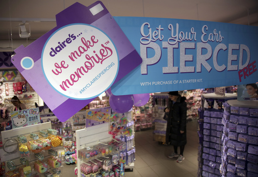 FILE - People shop at a Claire's in New York, Saturday, March 17, 2018. (AP Photo/Seth Wenig, File)