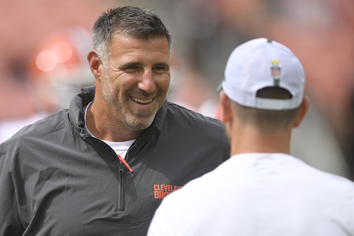 FILE - Cleveland Browns coaching and personnel consultant Mike Vrabel, left, stands on the field before an NFL preseason football game against the Green Bay Packers, Aug. 10, 2024, in Cleveland. (AP Photo/David Richard, File)