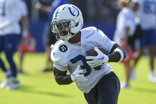 FILE - Indianapolis Colts running back Salvon Ahmed (36) runs a drill during practice at the NFL football team's training camp in Westfield, Ind., July 23, 2025. (AP Photo/Michael Conroy, file)